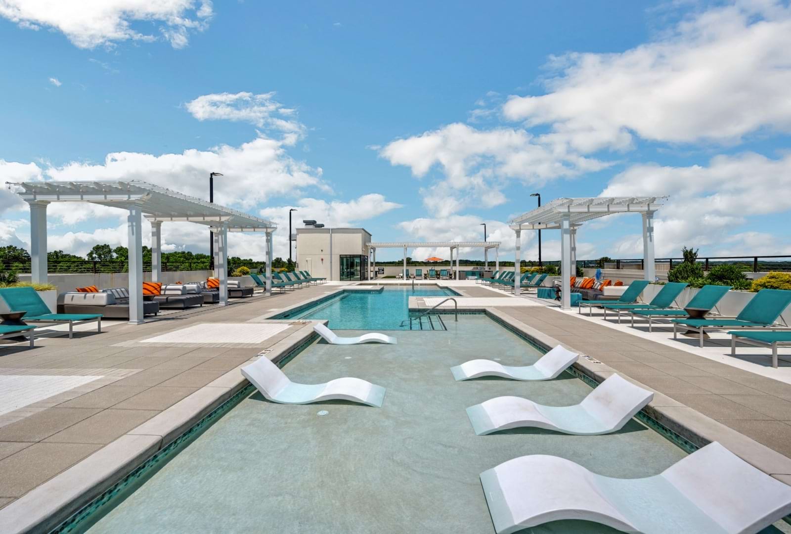 resort style pool with lounge chairs in the water